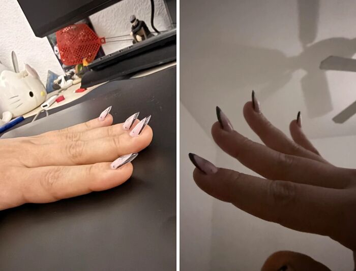 A person's hands show extreme stiletto acrylic beauty disasters, with mismatched lengths and crooked application from a salon.