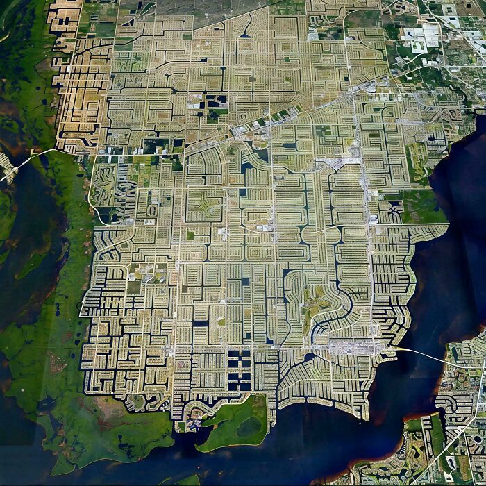 Aerial view of suburban urban hell with dense grid of identical houses and roads