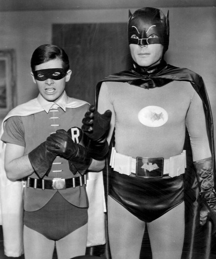 Black and white image of Batman and Robin costumes from 1960s TV show, reflecting cultural trends from year born.