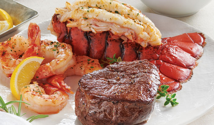 Surf and turf dish with grilled shrimp, lobster tail, and a seasoned steak, illustrating social media post planning mistakes.