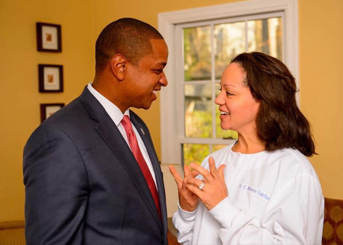 Virginia Lt. Governor Justin Fairfax in a suit speaking with a woman indoors, related to 911 call holes in her shirt case.
