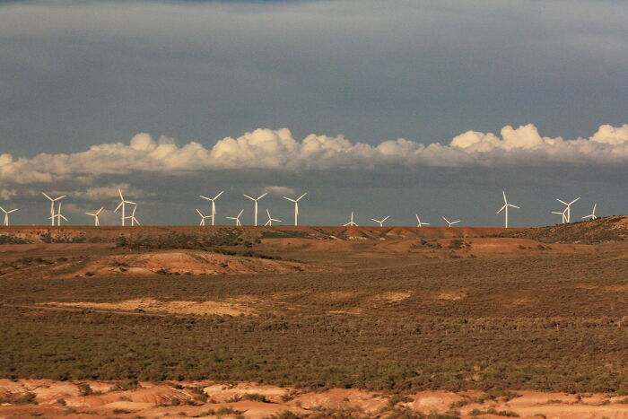 Wind turbines scattered across a barren landscape in one of the worst places in the US that people have visited.