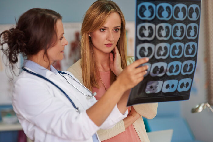 Doctor explaining medical scan results to a concerned patient learning random facts about their body during a checkup.