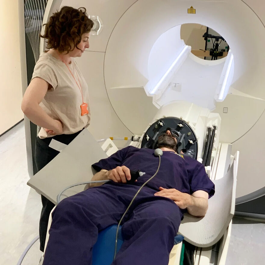 Researcher monitors a man in an MRI scanner. They are investigating bizarre human body quirks using neuroimaging.