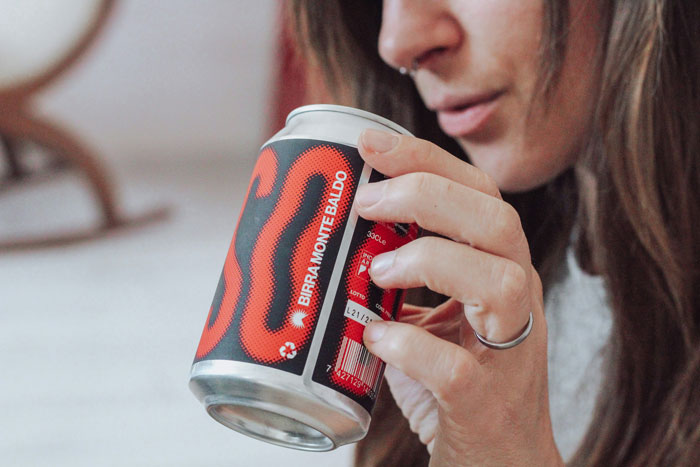 A woman with a nose ring holding a beer can. Dating moments can reveal a person's true character.