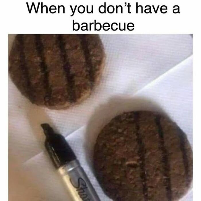 Two grilled burger patties on a napkin with a black marker pen mimicking barbecue grill marks, food memes humor.