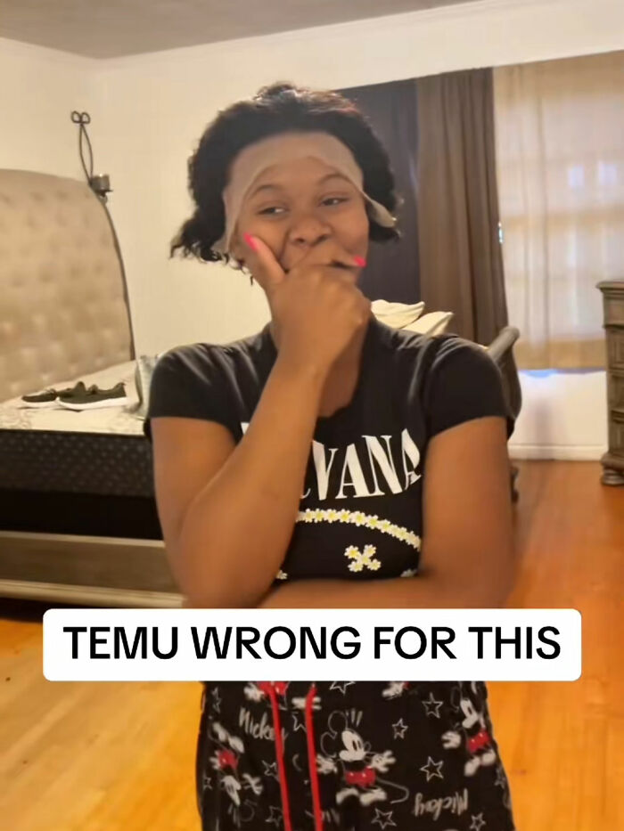 Woman laughing with a hairpiece on forehead, reacting to a funny lesson from a Temu order in a bedroom setting.