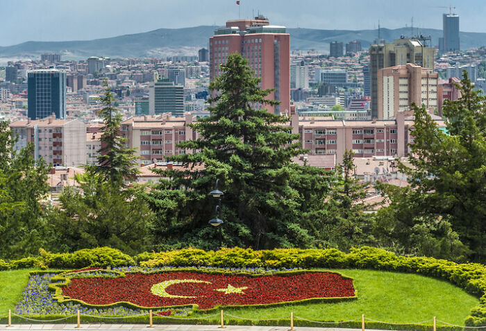 Ankara, Turkey skyline with a flowerbed in the shape of the Turkish flag. A country often cited for its worst work-life balance.