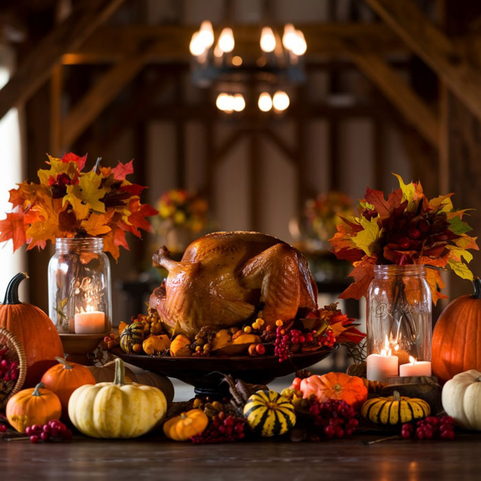 A roasted turkey centerpiece on a table adorned with fall decor, pumpkins, and candles. Spotting dumb moments.