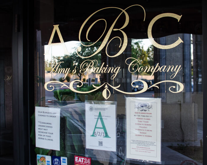 Window of a bakery with gold lettering and posted notices showing common PR mistakes companies did not expect to backfire.