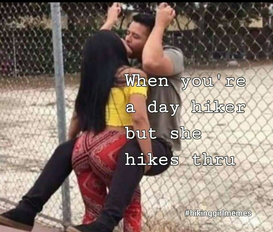 Couple using a chain-link fence with hiking meme text about day hikers, illustrating camping and hiking humor.