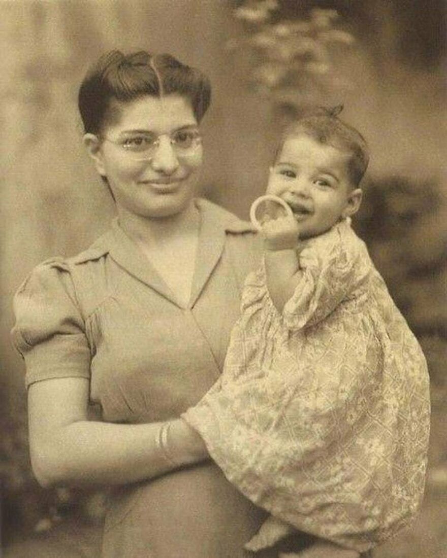 Sepia photo of a woman holding a smiling baby. History in a way school can't. Fascinating photos.