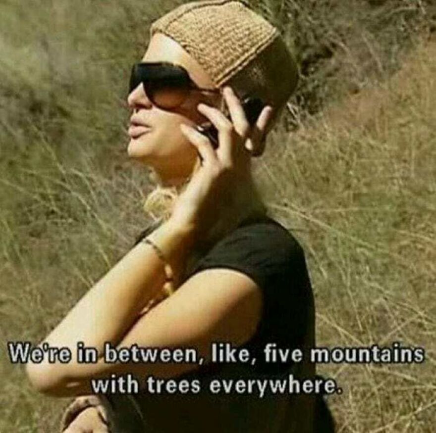 Woman wearing sunglasses and a knit hat talking outdoors with hiking memes about mountains and trees everywhere.
