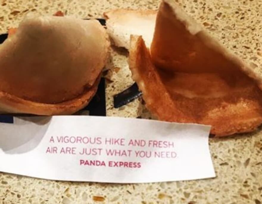Fortune cookie with message about hiking and fresh air, part of camping and hiking memes to connect with nature.