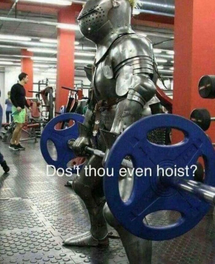 Person in full medieval armor lifting weights at the gym, a humorous Darwin Award contender workout moment.