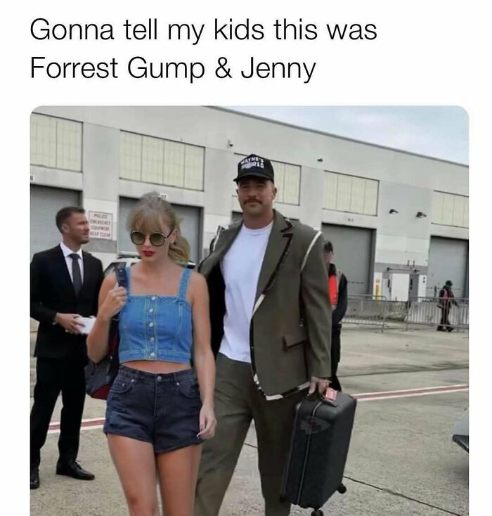 Couple dressed in casual 90s style clothing walking outside near an industrial building, evoking 90s memes nostalgia.