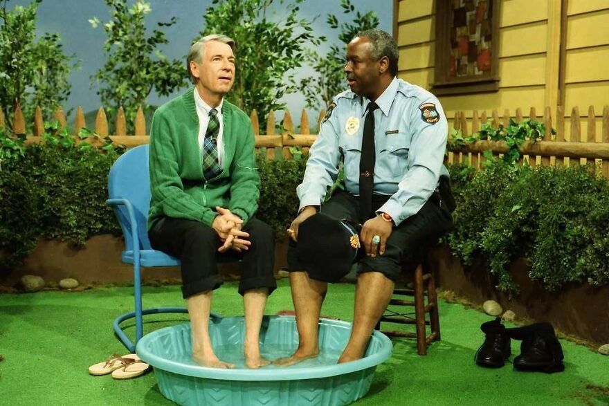 Mr. Rogers and an officer soak their feet in a tub, offering a fascinating photo that teaches about history.