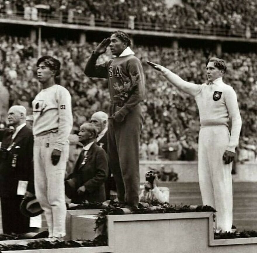 Fascinating photos teach history: Jesse Owens saluting on a podium while a competitor gives the N**i salute.
