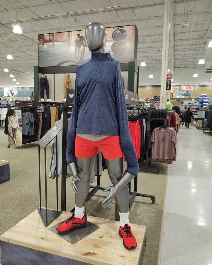 A cursed image of a mannequin in a store with unusually long, bent arms, confusing and amusing viewers.