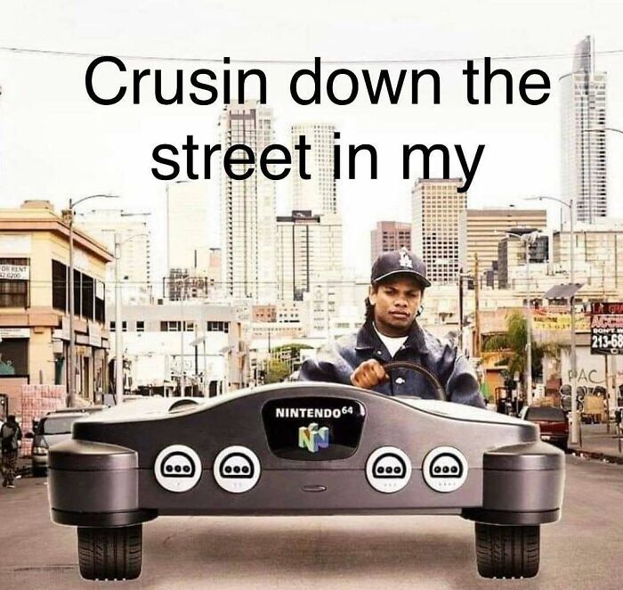 Man driving a Nintendo 64 console car in a city street, a popular 90s meme evoking nostalgia and retro gaming.