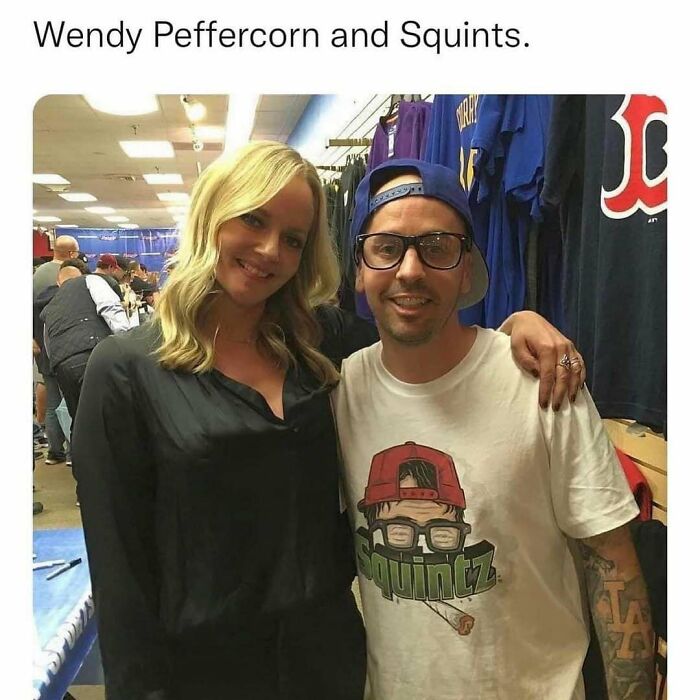 Two people posing indoors wearing a Squints t-shirt and casual black top, evoking 90s memes and nostalgia culture.