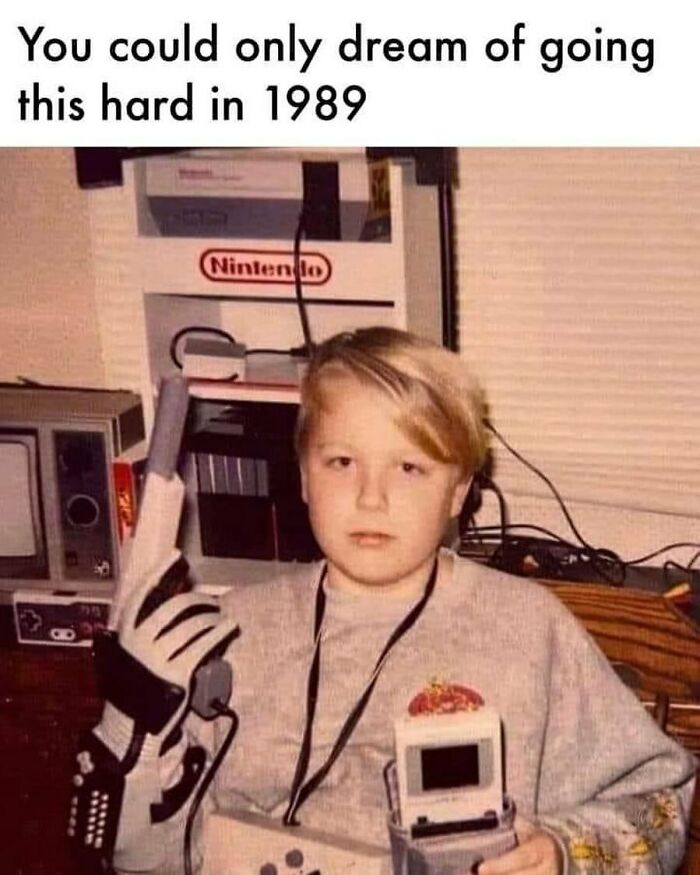 Child holding vintage gaming accessories and wearing a Nintendo glove, showcasing 90s nostalgia and retro video game culture.