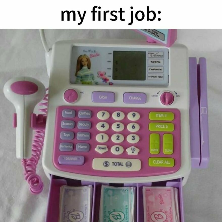 A pink and white Barbie toy cash register with play money, a nostalgic photo capturing the vibe of growing up in the 2000s.