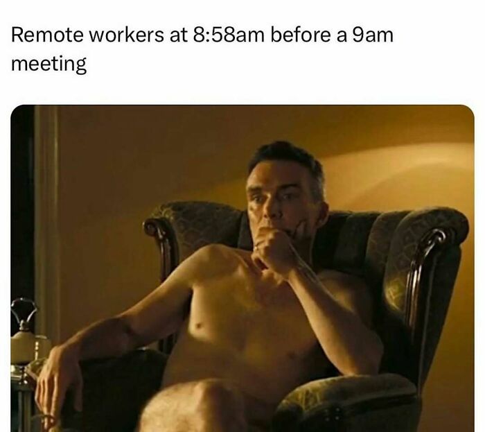 Shirtless man sitting thoughtfully in an armchair representing remote workers in a wild meme about early morning meetings.