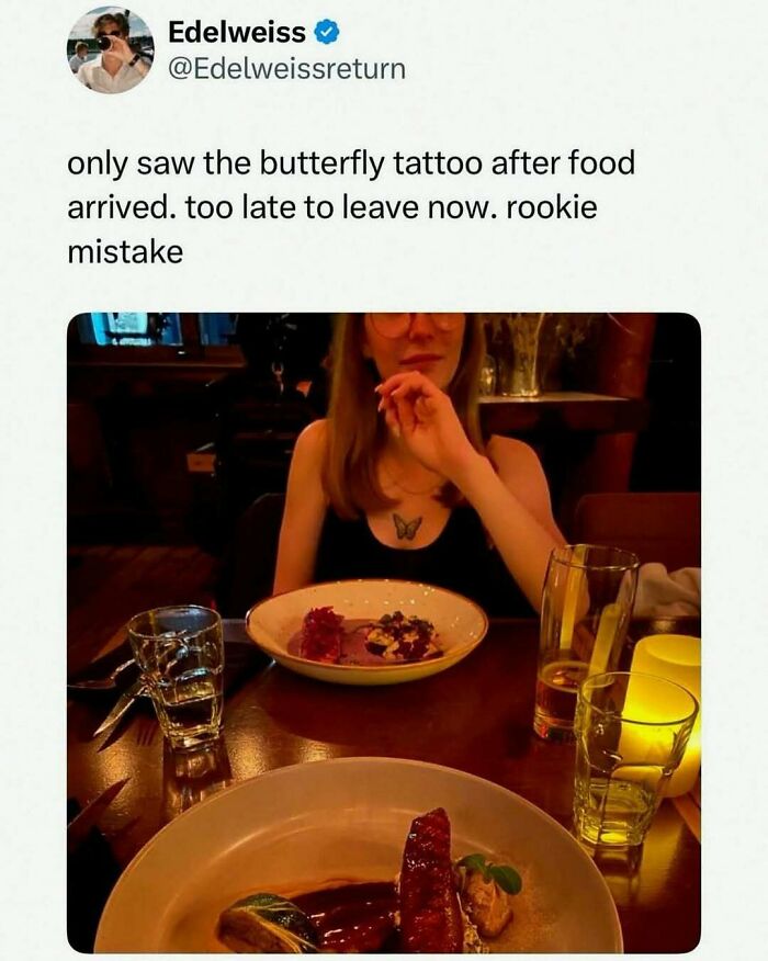 Tweet showing a woman with a butterfly tattoo at dinner, illustrating an unhinged and wild meme about awkward moments.