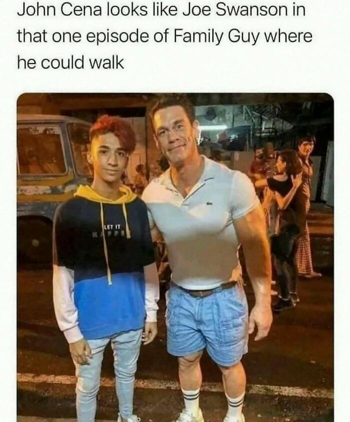 Two men posing on a street at night, one with red hair wearing a hoodie, the other muscular in a white shirt and shorts, wild memes vibe.