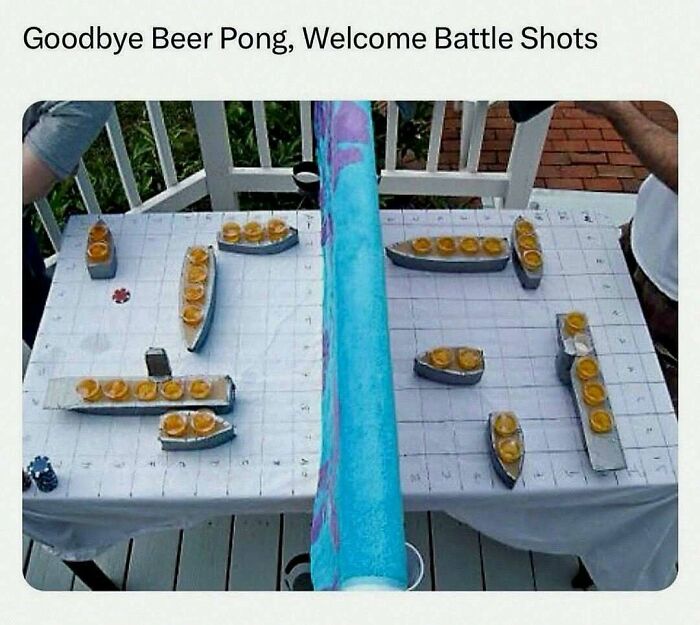 Table set for a wild battle shots game with shot glasses arranged like ships, perfect for unhinged and wild memes amusement.