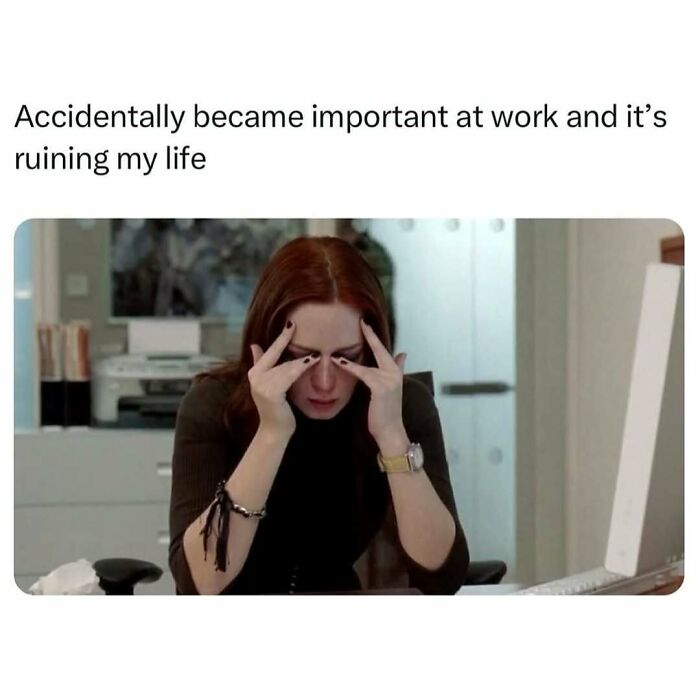 Person stressed at work with hands on face, illustrating relatable memes about adulthood being harder than expected.