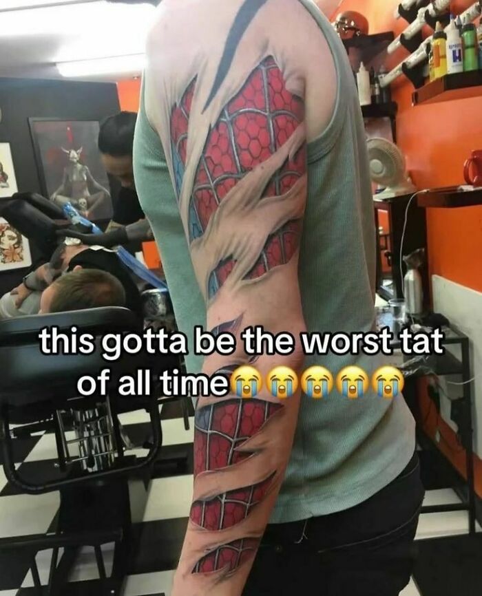 A person's arm with an unhinged, Spiderman ripped-skin tattoo, making it a hilarious pic that makes no sense.