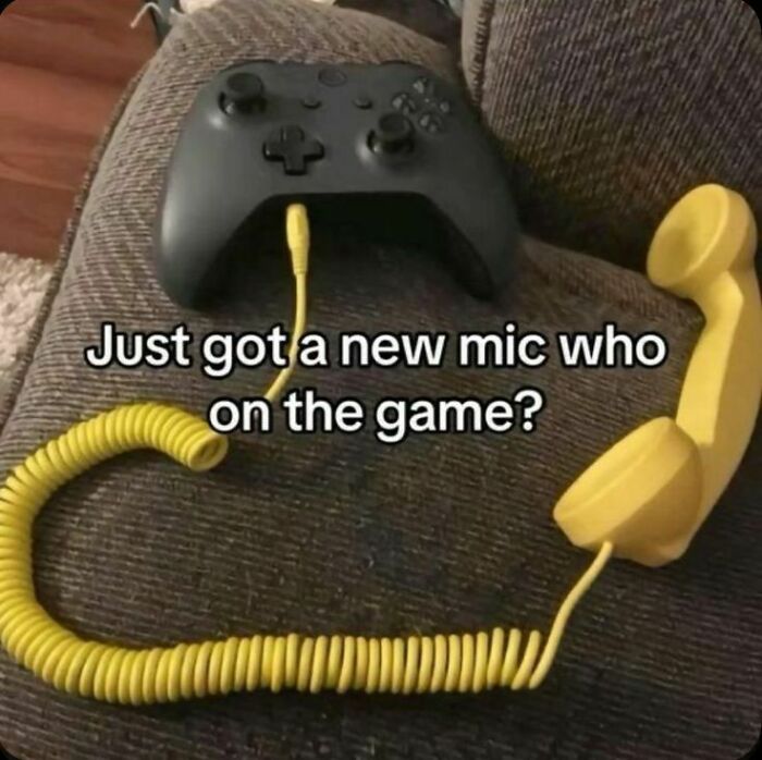 A hilarious, unhinged pic of a game controller connected to an old yellow phone receiver as a mic.