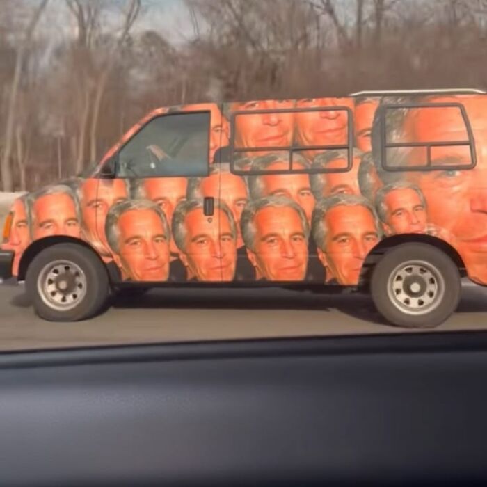 A van covered with numerous repeated images of Jeffrey Epstein's face, an unhinged pic that makes absolutely no sense but is hilarious.