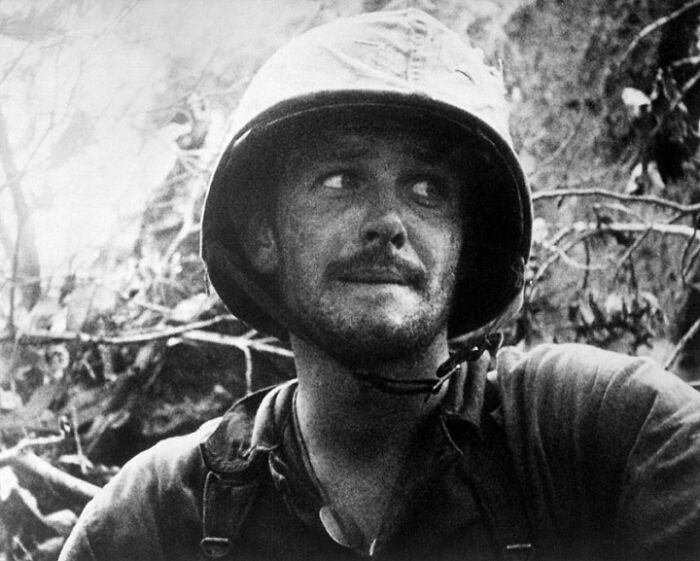 Black-and-white historical photo of a soldier in a helmet, representing a vastly different world from today.