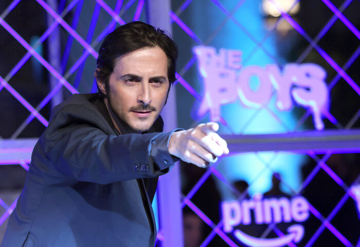 Actor from The Boys series pointing forward at an event with The Boys and Prime logos in the background amid controversy over army history. Actor from The Boys series pointing forward at an event with The Boys and Prime logos in the background amid controversy over army history.