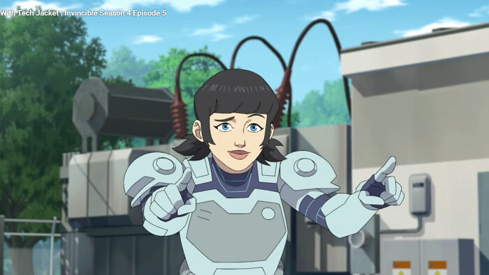 Tech Jacket from Invincible Season 4 in armored suit, animated character pointing forward in outdoor industrial setting.
