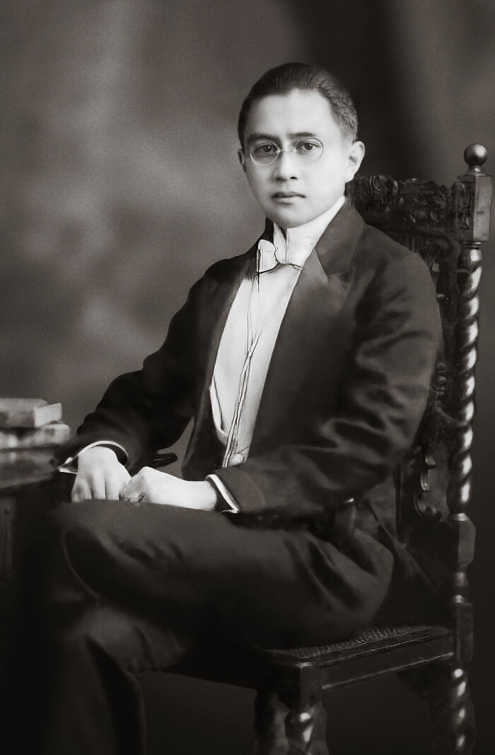 Vintage portrait of a young man in formal attire sitting on an ornate chair, rare and interesting photo from past times.