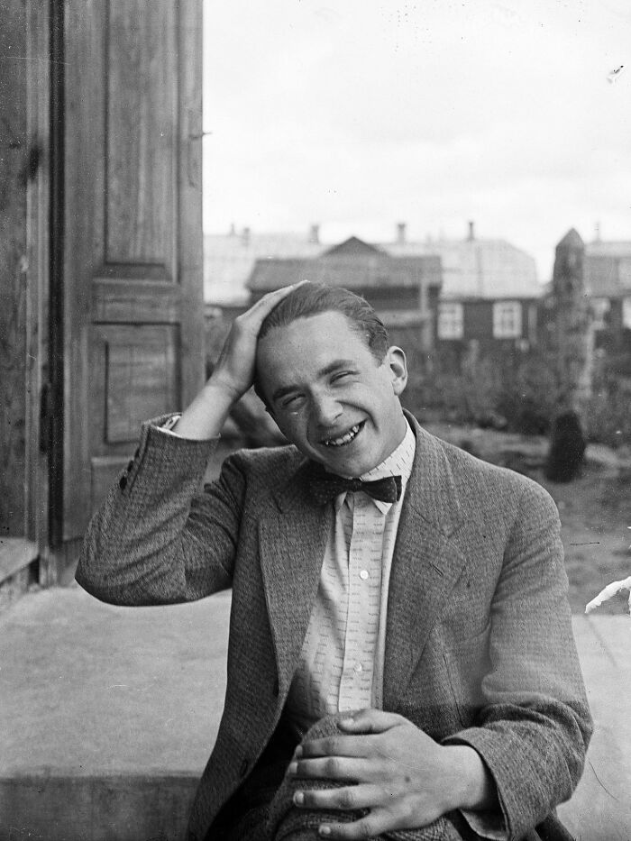 Black and white vintage photo of a smiling man in a bow tie, rare and interesting photos from a time past.