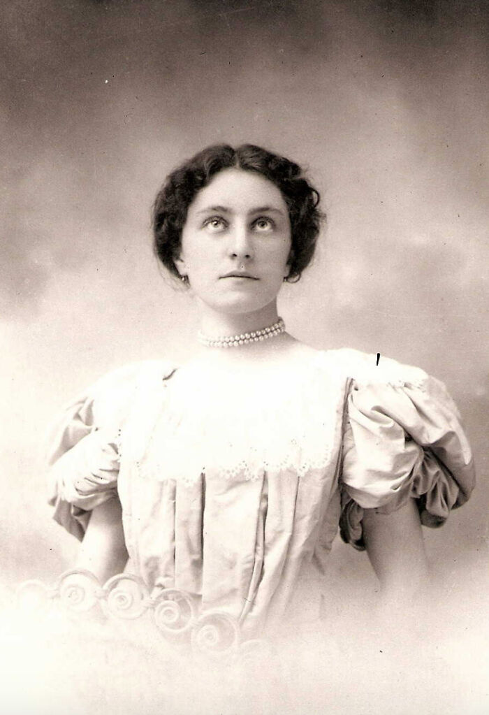 Vintage photo of a woman in a pearl necklace and puffed sleeve dress from rare and interesting historic moments.