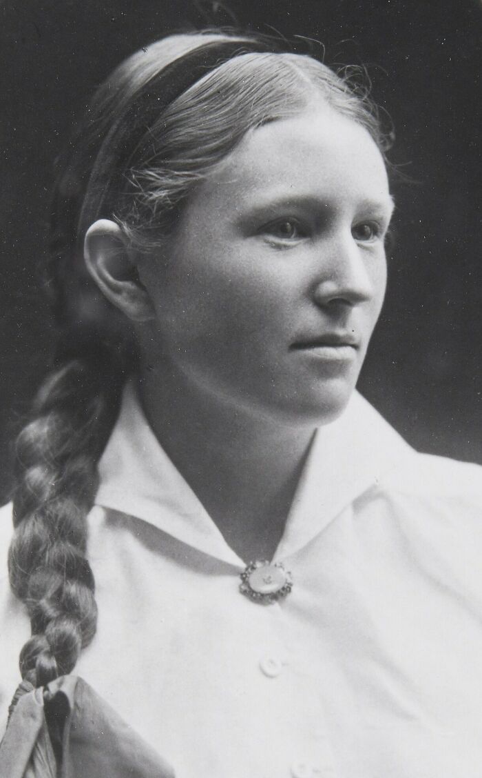 Black and white rare photo of a young woman with braided hair from a time we will never get to experience.