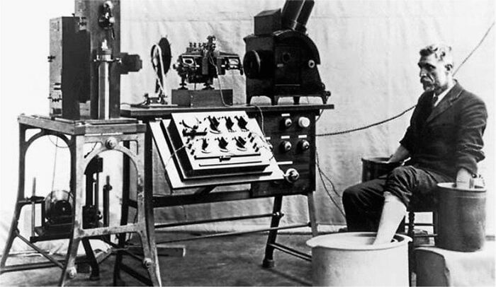 Vintage medical devices with early diagnostic equipment and a patient seated during historical healthcare testing.