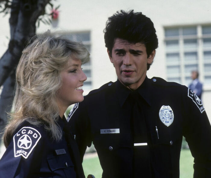 Two 80s icons in police uniforms smiling and talking, now in their 60s sparking fan frenzy with confirmed romance. Two 80s icons in police uniforms smiling and talking, now in their 60s sparking fan frenzy with confirmed romance.