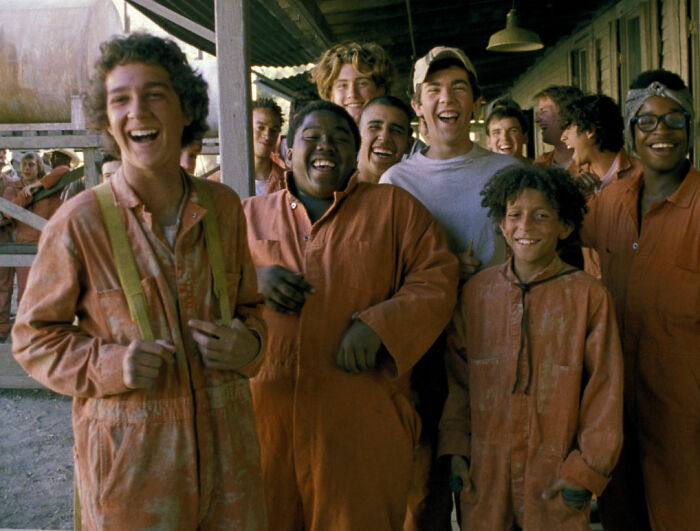 Group of young actors smiling and laughing on set, related to Bryan Cranston’s brutal and direct remarks on Shia LaBeouf.