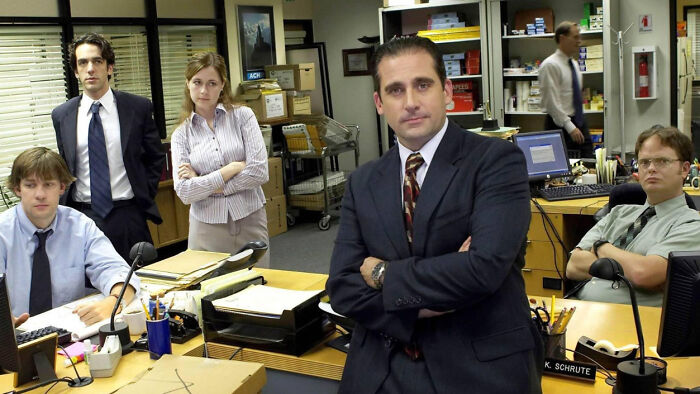 The Office cast, including Michael, Pam, Jim, Ryan, and Dwight, posing in the Dunder Mifflin office. Dundie Award.