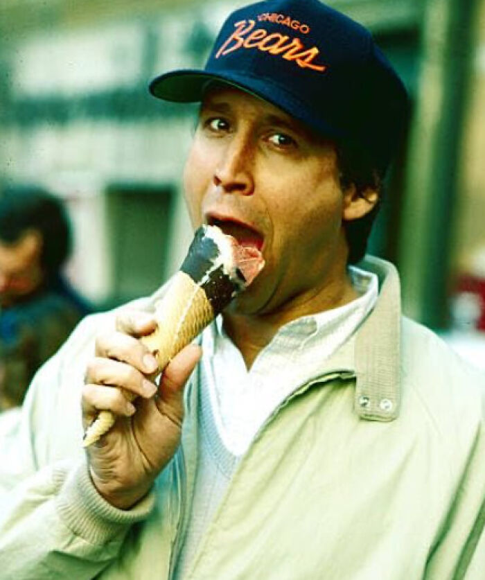 Man wearing Chicago Bears cap enjoying an ice cream cone, sharing amazing and interesting stories about their moms.