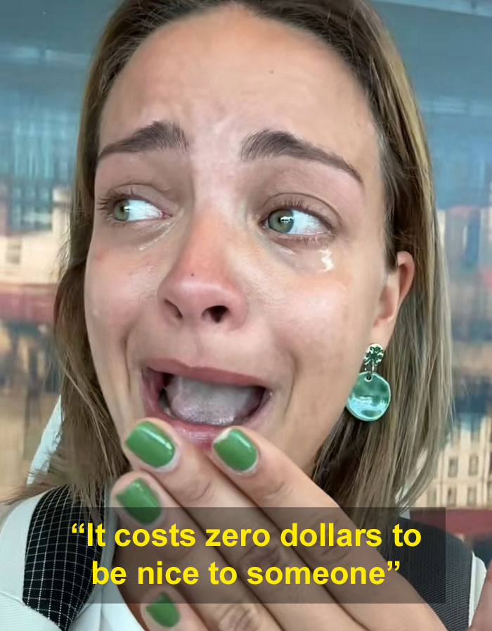 Woman with green nail polish and earrings crying at airport, illustrating a health and wellness girly's airline wake-up call.