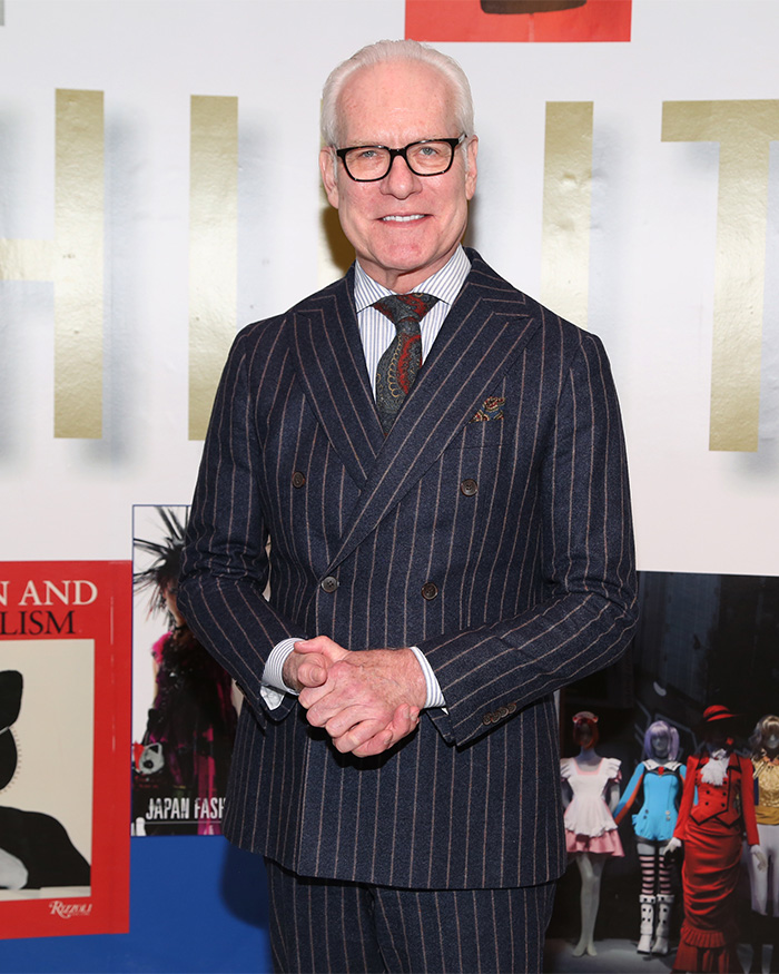 Tim Gunn, a celebrity in a pinstriped suit, smiling at an event. Perhaps he hated the Met Gala too.