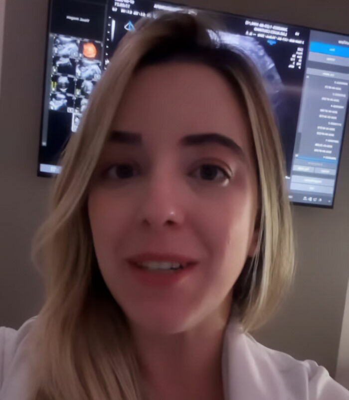 Pregnant doctor sharing a viral video showing her baby peeing inside the womb on a screen in a medical setting.